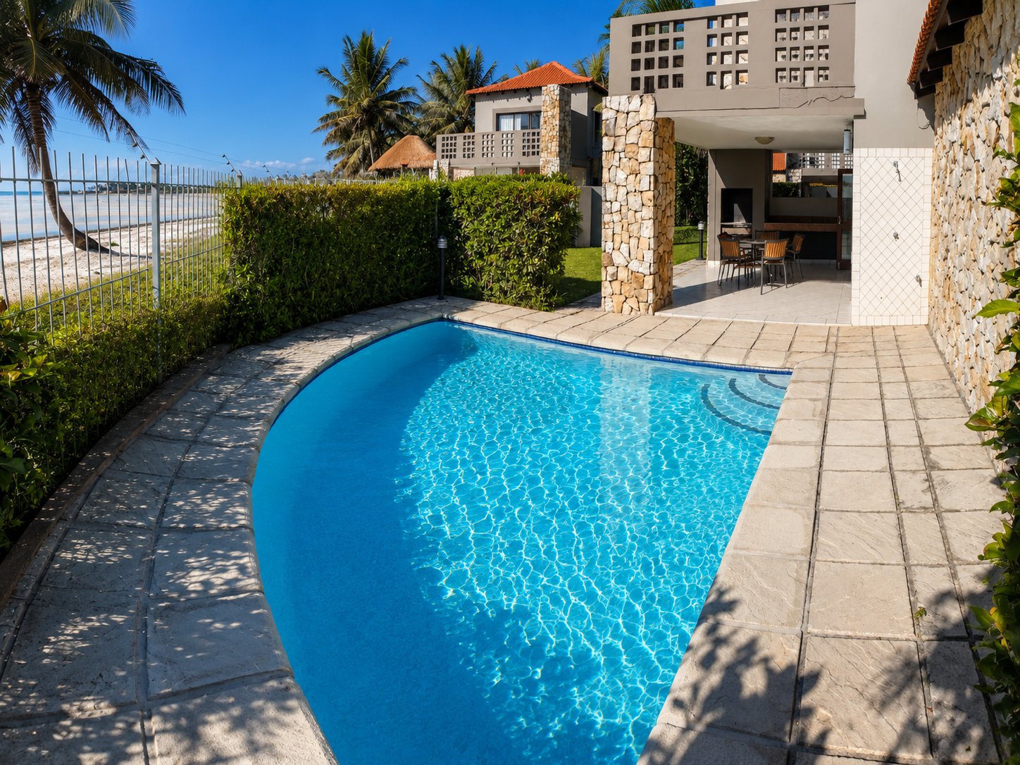 A Giney's View private plunge pool beside the beach fence